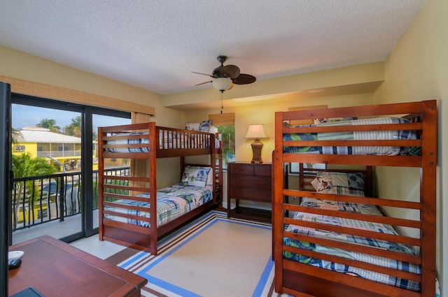 bedroom featuring access to outside and a textured ceiling