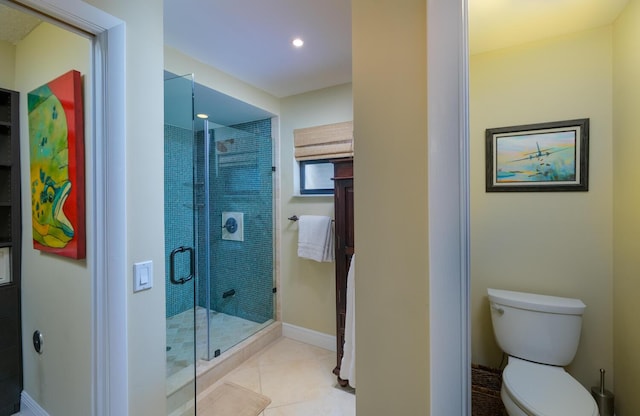 bathroom featuring a shower with shower door, tile patterned floors, and toilet