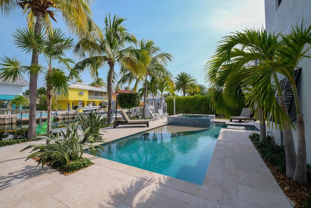 view of pool with an in ground hot tub and a patio