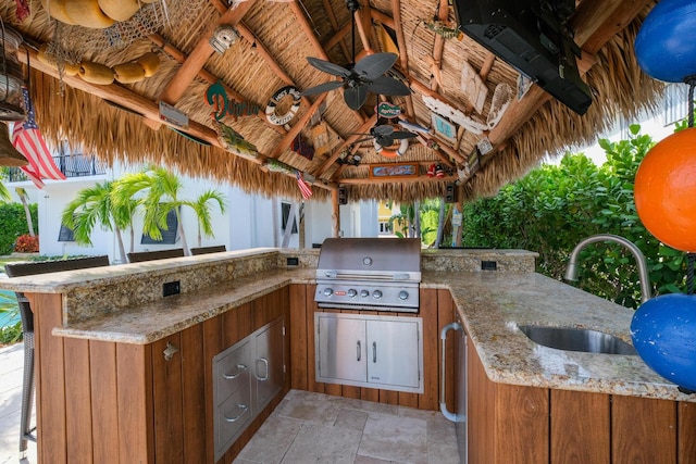 view of patio with sink, a gazebo, ceiling fan, a grill, and exterior kitchen