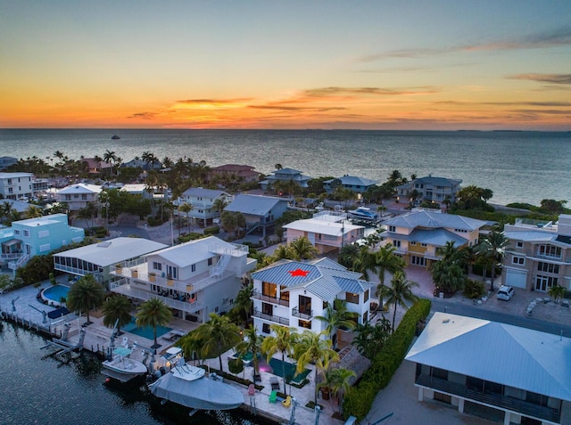 aerial view at dusk with a water view