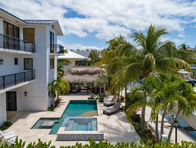 view of pool featuring an in ground hot tub, a patio, and a gazebo