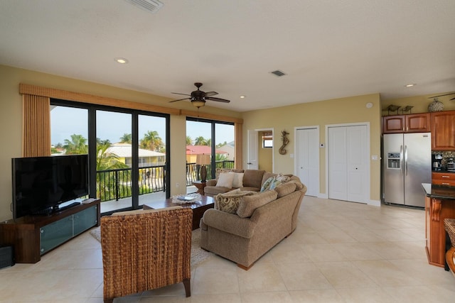 living room featuring light tile patterned flooring and ceiling fan