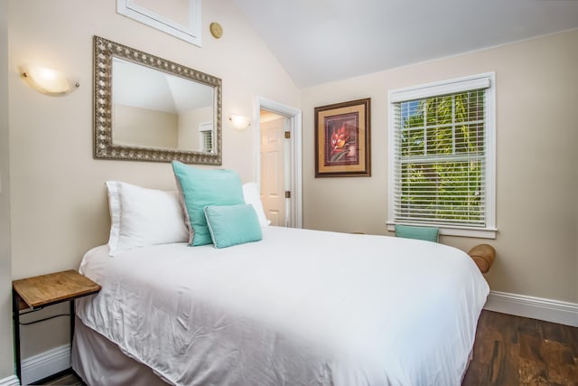 bedroom with dark wood-type flooring and vaulted ceiling