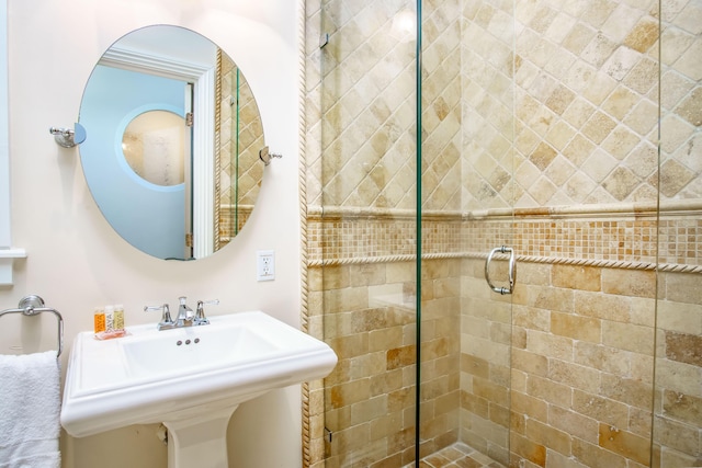 bathroom featuring walk in shower and sink