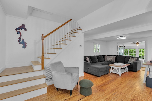 living room with crown molding and hardwood / wood-style flooring