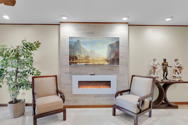 living area with ornamental molding, a fireplace, and light tile patterned floors