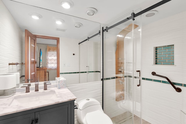 bathroom with vanity, toilet, an enclosed shower, and tile walls