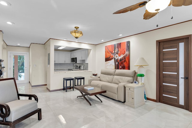 living room featuring ornamental molding and ceiling fan