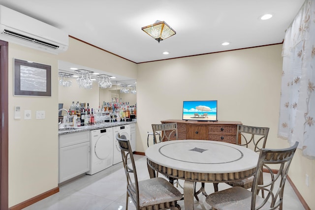 dining area with ornamental molding, washer / clothes dryer, wet bar, and an AC wall unit