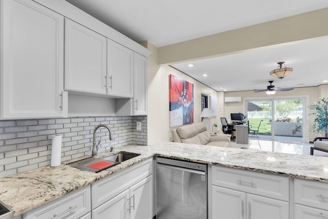 kitchen featuring sink, dishwasher, white cabinetry, backsplash, and a wall unit AC