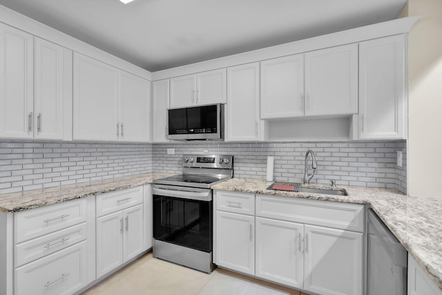 kitchen with tasteful backsplash, appliances with stainless steel finishes, sink, and white cabinets