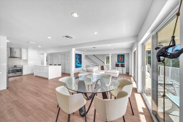 dining space with light hardwood / wood-style flooring