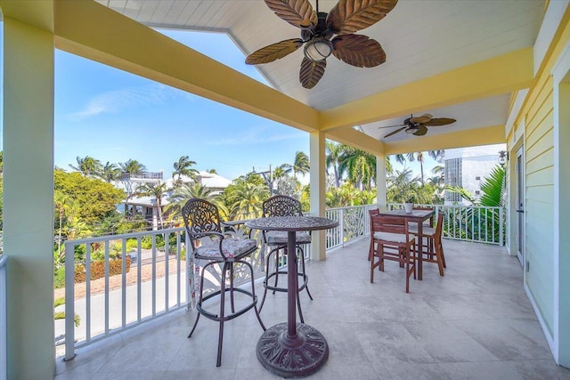 view of patio featuring ceiling fan and a balcony