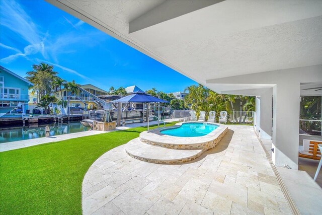 view of swimming pool with a gazebo, a water view, and a patio area