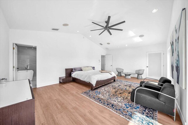 bedroom featuring lofted ceiling and light hardwood / wood-style flooring