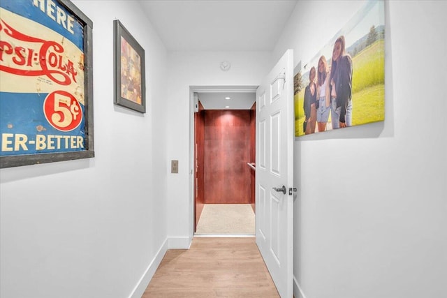 hallway with light hardwood / wood-style flooring