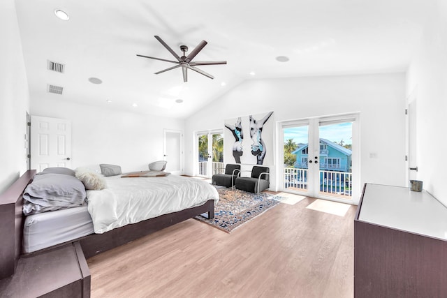 bedroom featuring high vaulted ceiling, access to outside, ceiling fan, light wood-type flooring, and french doors