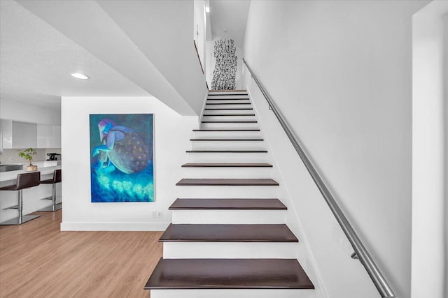 staircase featuring hardwood / wood-style floors