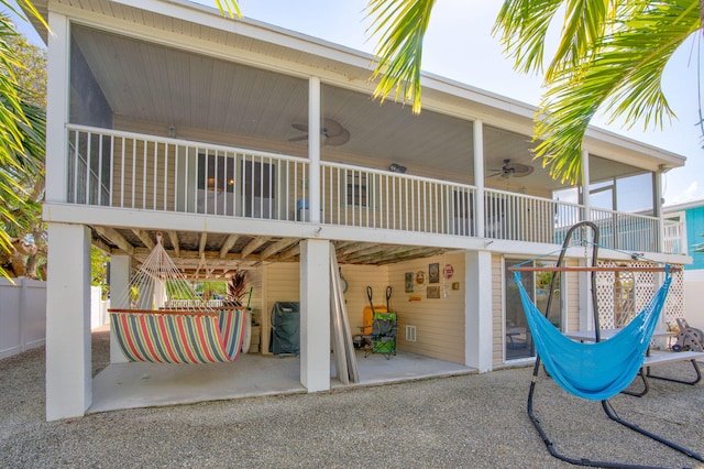 back of house with ceiling fan and a patio