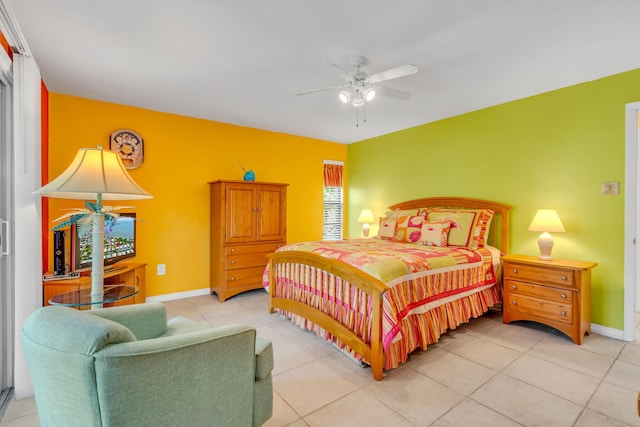 bedroom featuring ceiling fan, light tile patterned flooring, and baseboards