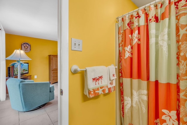 bathroom featuring curtained shower and tile patterned floors