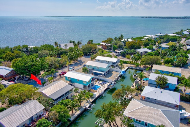 birds eye view of property with a water view and a residential view