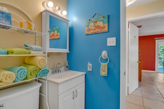 bathroom with toilet, visible vents, tile patterned flooring, and vanity