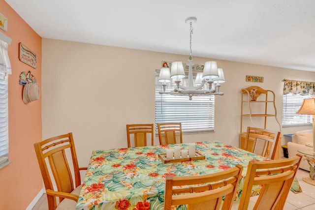 dining room featuring baseboards and a notable chandelier