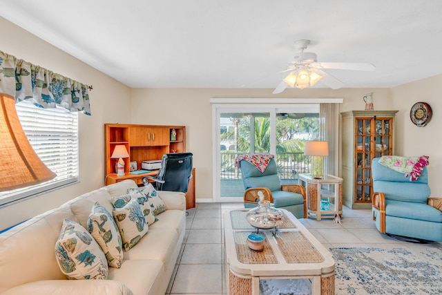 tiled living room with baseboards and a ceiling fan