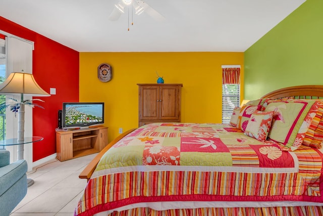 tiled bedroom with a ceiling fan and baseboards