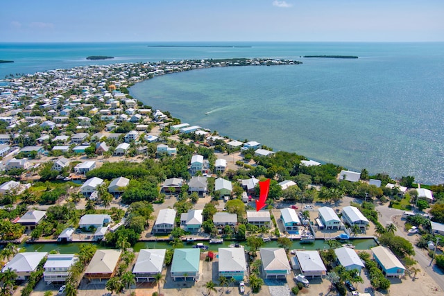 drone / aerial view with a water view and a residential view