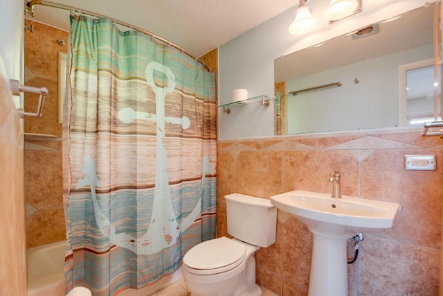 bathroom with tile walls, shower / tub combo with curtain, and toilet