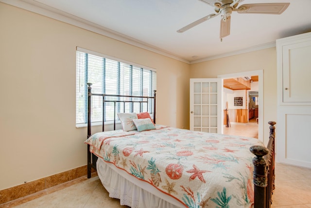 bedroom featuring a ceiling fan, crown molding, baseboards, and light tile patterned floors