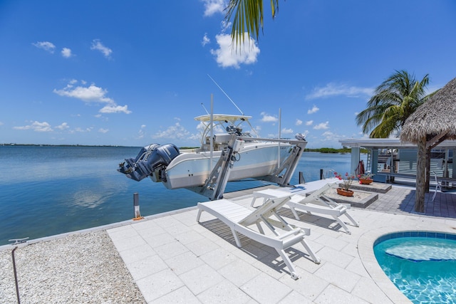 view of dock with a patio area, a water view, and boat lift