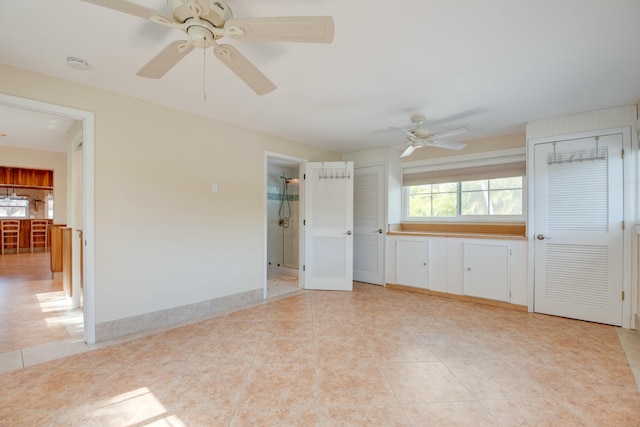 spare room with light tile patterned flooring and ceiling fan