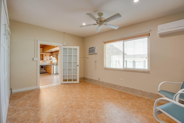 living area with light tile patterned floors, a ceiling fan, an AC wall unit, a wall mounted air conditioner, and baseboards