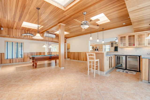 interior space featuring wine cooler, a wall unit AC, wood ceiling, wainscoting, and plenty of natural light