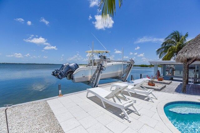 view of pool featuring a water view, a patio area, and a gazebo