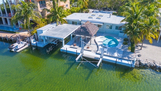 view of dock with a patio area, a water view, and boat lift