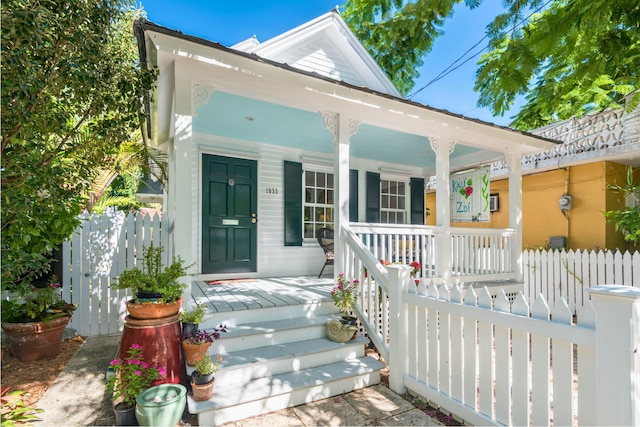 exterior space with covered porch and fence