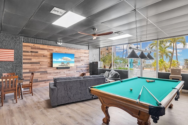 recreation room with visible vents, plenty of natural light, a ceiling fan, and wood finished floors