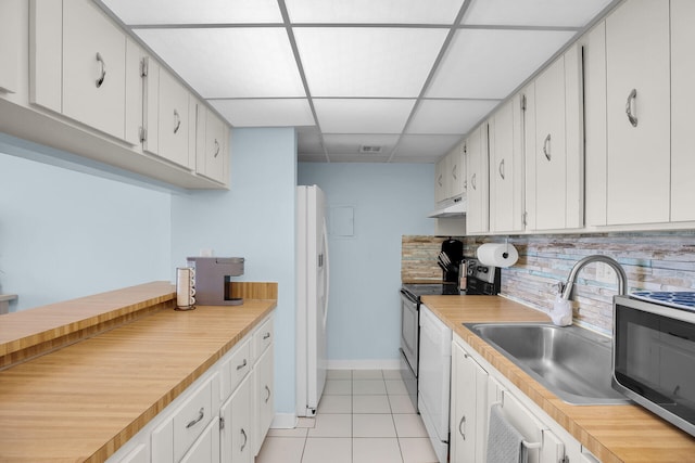kitchen with under cabinet range hood, white appliances, and light countertops