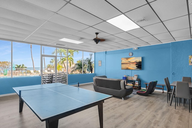 recreation room featuring visible vents, a paneled ceiling, baseboards, and wood finished floors