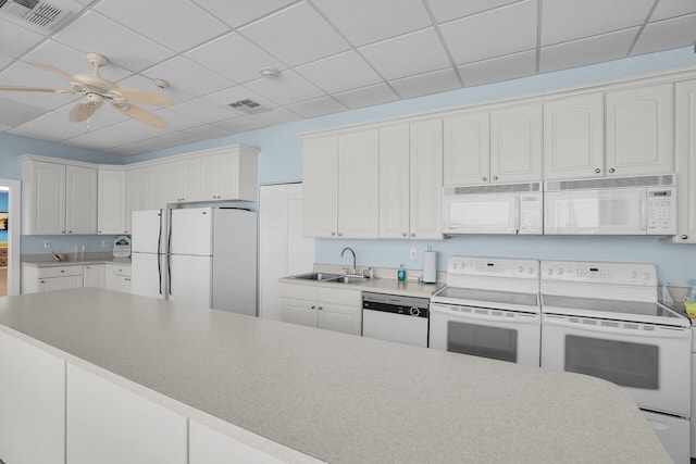 kitchen featuring visible vents, white appliances, ceiling fan, and a sink