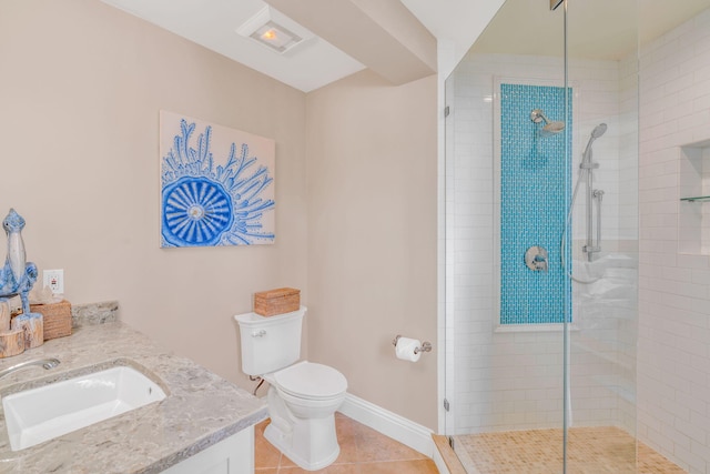 bathroom with vanity, tile patterned floors, toilet, and tiled shower