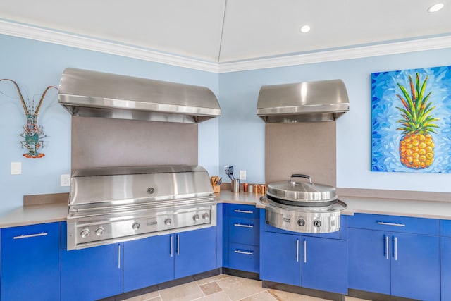 kitchen with range hood, wall chimney range hood, crown molding, and blue cabinetry