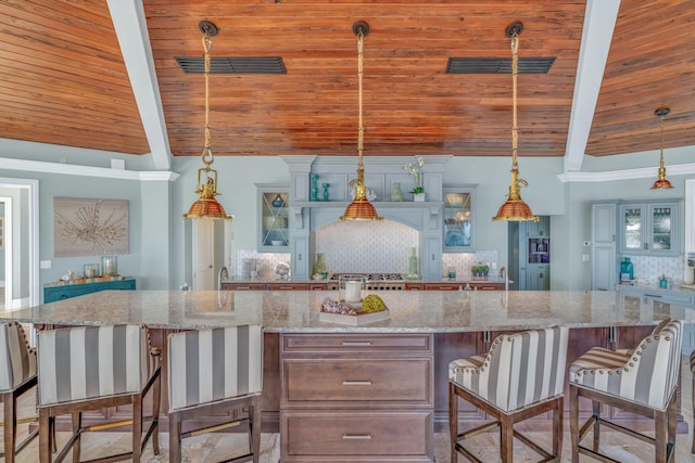 kitchen featuring decorative light fixtures, a center island, and decorative backsplash