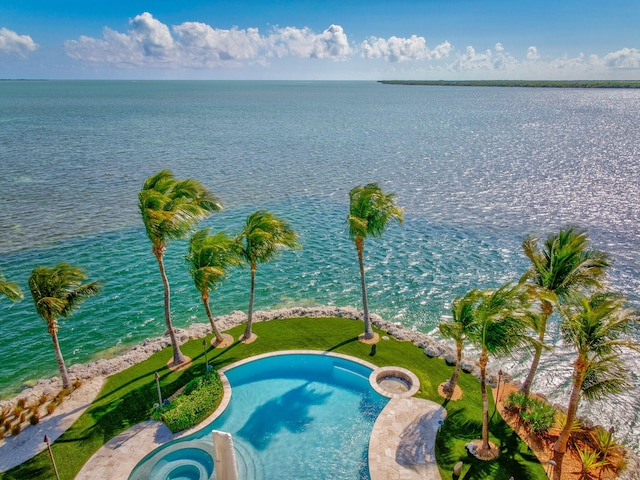 view of pool with a water view and an in ground hot tub