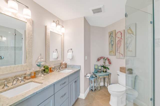 bathroom featuring vanity, toilet, an enclosed shower, and tile patterned flooring